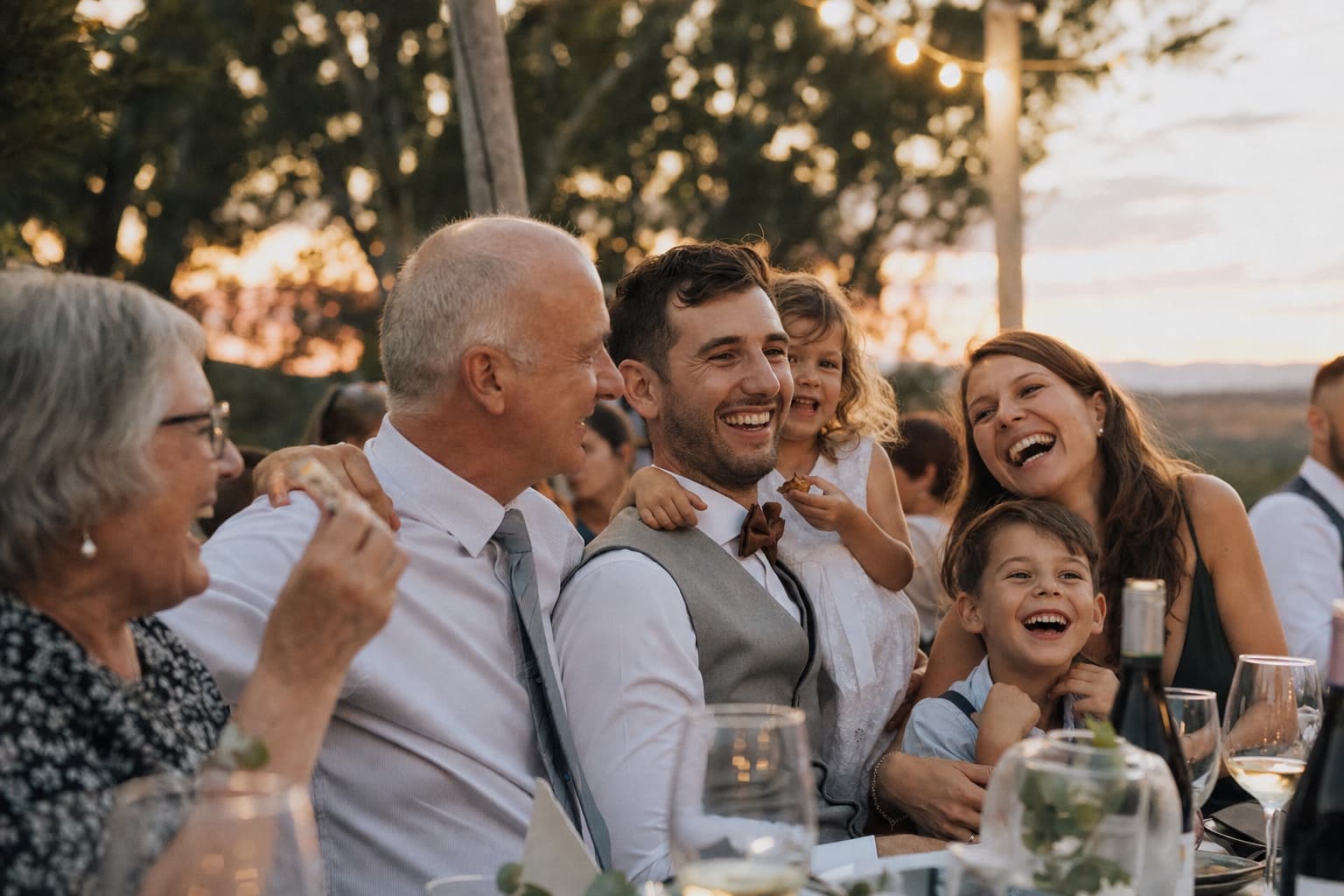 Family laughing together during an outdoor celebration