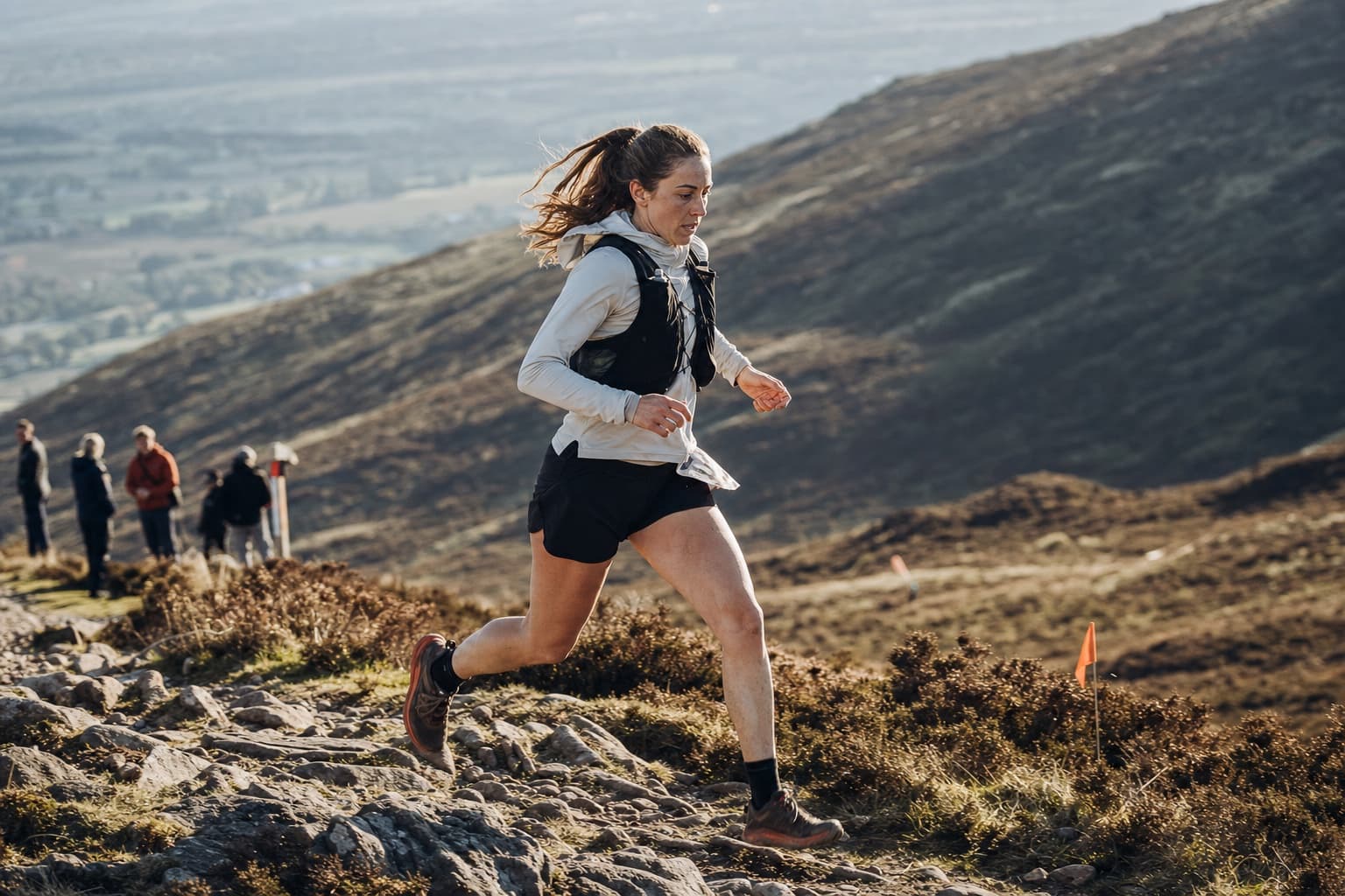 Runner moving quickly across a rugged hillside