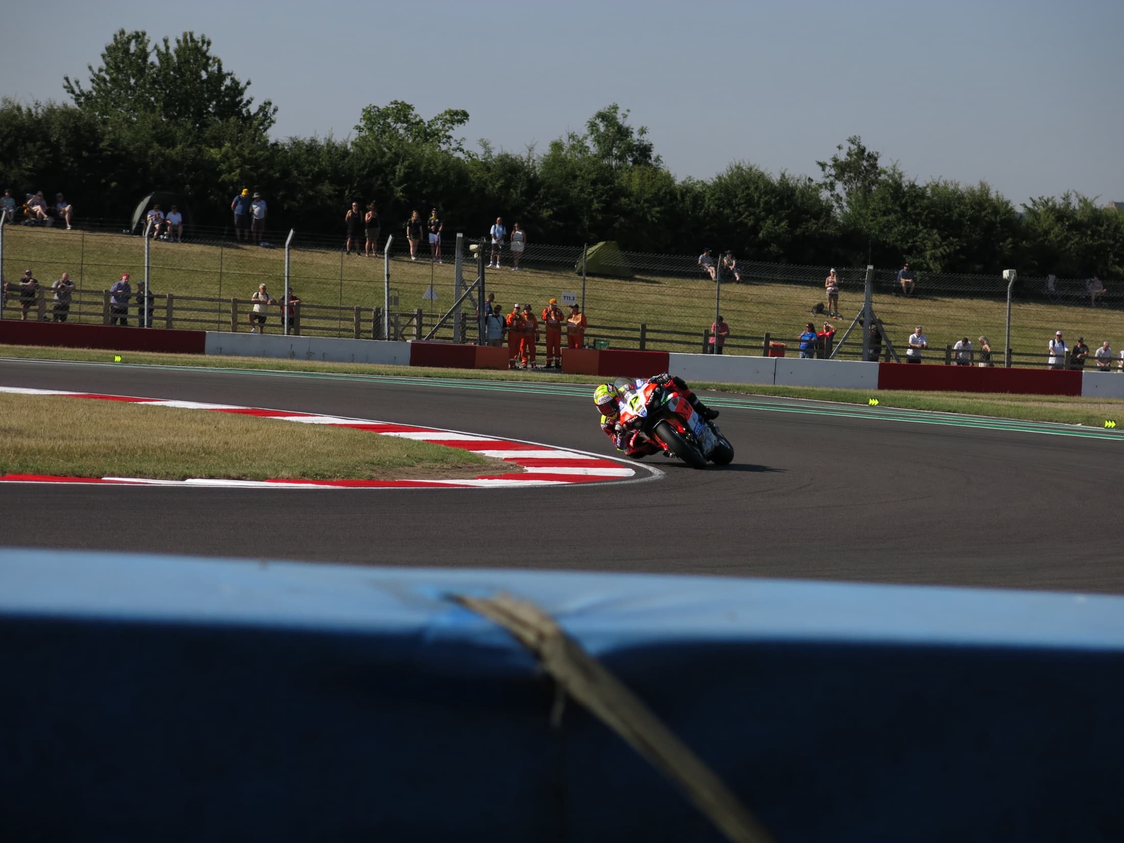 Two superbikes leaning together through a circuit corner