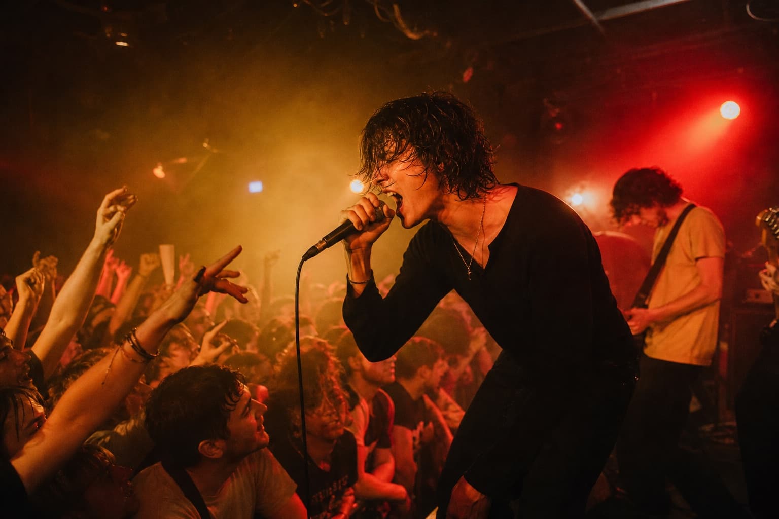 Singer performing closely to an energetic crowd